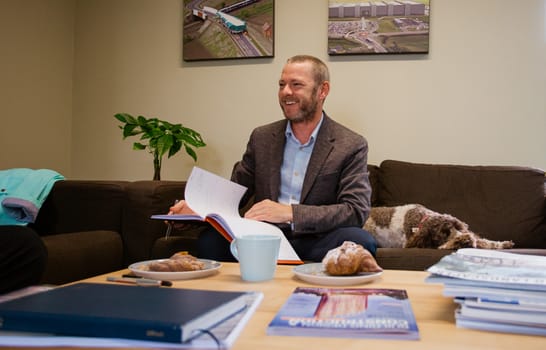 Picture of Axis businessman with dog on sofa